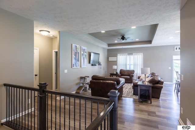 5614 N 177th St, Omaha, NE 68116 - living area featuring wood finished floors, a ceiling fan, a raised ceiling, baseboards, and recessed lighting