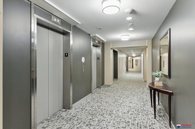 3201 Dodge Ct Unit 5412, Omaha, NE 68131 - corridor featuring elevator, baseboards, and light carpet