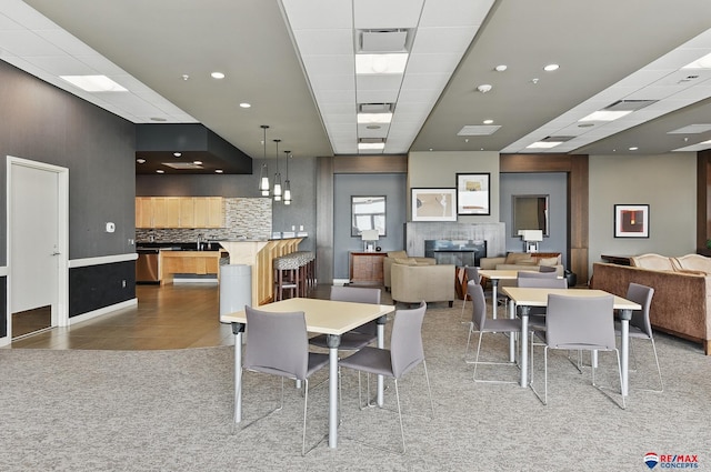 3201 Dodge Ct Unit 5412, Omaha, NE 68131 - dining room with a glass covered fireplace, light tile patterned floors, light carpet, and recessed lighting