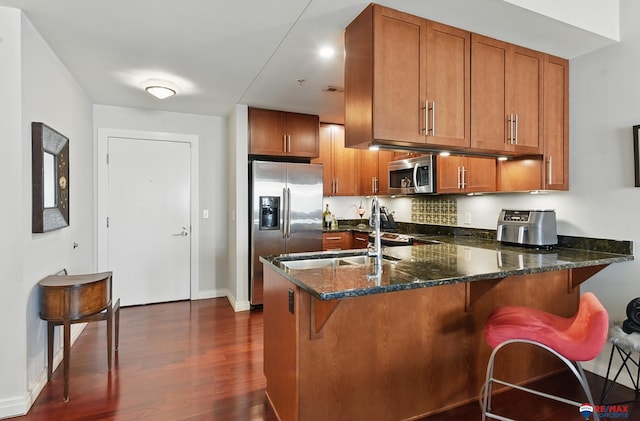 3201 Dodge Ct Unit 5412, Omaha, NE 68131 - kitchen featuring stainless steel appliances, brown cabinets, and a peninsula
