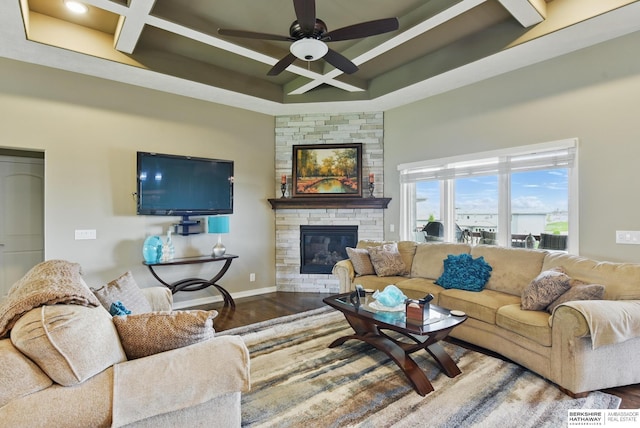 235 N 10th Ave, Springfield, NE 68059 - living room featuring wood finished floors, a stone fireplace, a ceiling fan, and baseboards