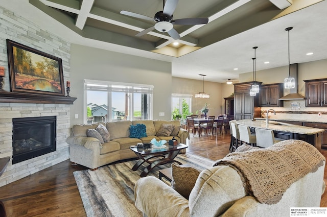 235 N 10th Ave, Springfield, NE 68059 - living room with recessed lighting, dark wood finished floors, coffered ceiling, a ceiling fan, and a fireplace