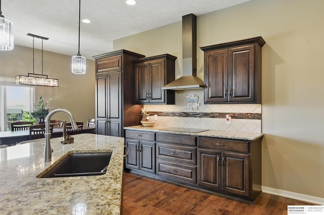 235 N 10th Ave, Springfield, NE 68059 - kitchen featuring wall chimney exhaust hood, a sink, dark brown cabinetry, decorative backsplash, and dark wood-style floors
