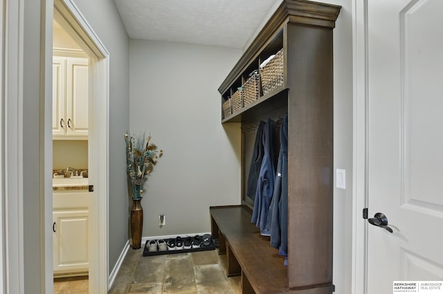 235 N 10th Ave, Springfield, NE 68059 - mudroom with baseboards, stone finish floors, and a textured ceiling