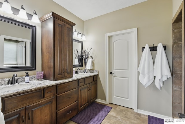235 N 10th Ave, Springfield, NE 68059 - full bathroom with baseboards, double vanity, and stone finish floors