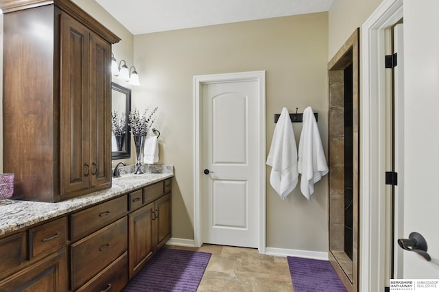 235 N 10th Ave, Springfield, NE 68059 - bathroom featuring vanity, baseboards, and a tile shower