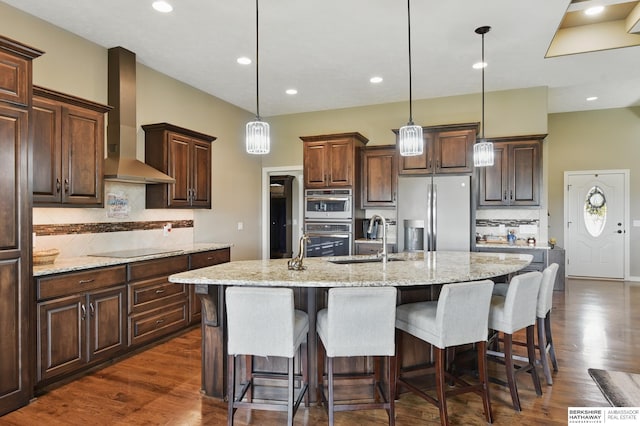 235 N 10th Ave, Springfield, NE 68059 - kitchen with stainless steel appliances, wall chimney range hood, a sink, backsplash, and an island with sink