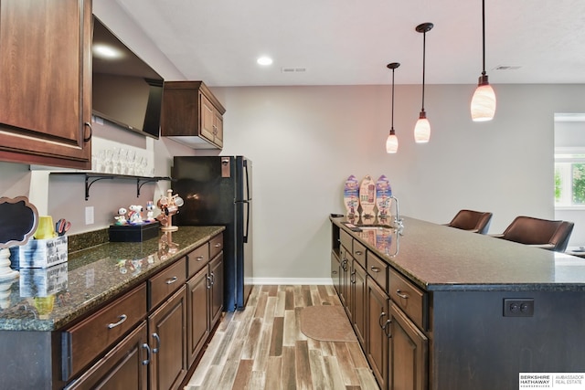 235 N 10th Ave, Springfield, NE 68059 - kitchen featuring a sink, freestanding refrigerator, light wood-style floors, baseboards, and hanging light fixtures