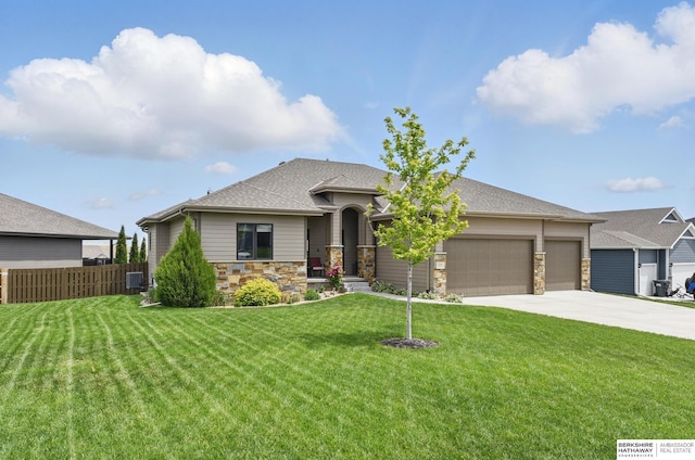 235 N 10th Ave, Springfield, NE 68059 - view of front facade featuring stone siding, a garage, concrete driveway, roof with shingles, and cooling unit