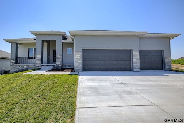 20145 S St, Omaha, NE 68135 - prairie-style home with stone siding, a garage, concrete driveway, a front lawn, and stucco siding