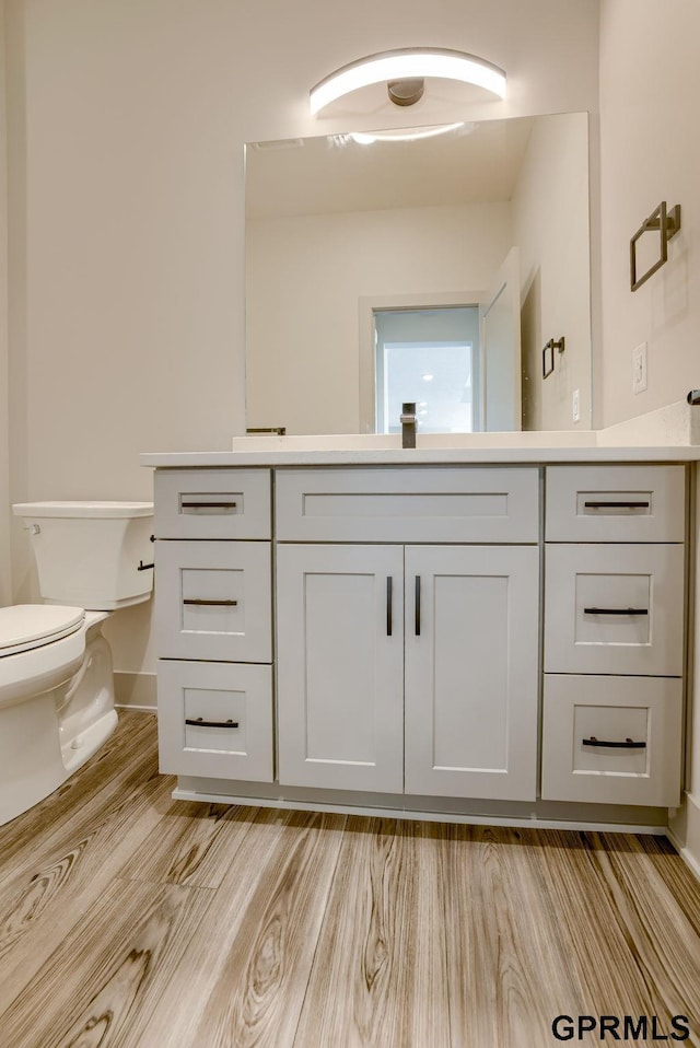 20145 S St, Omaha, NE 68135 - bathroom with vanity, toilet, wood finished floors, and baseboards