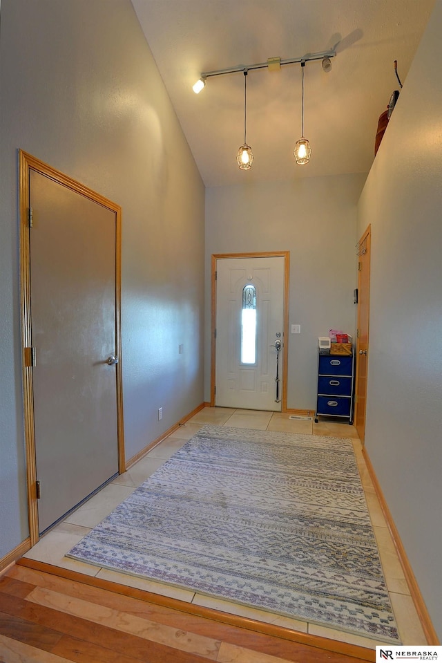10419 N 150th St, Bennington, NE 68007 - entrance foyer featuring high vaulted ceiling, baseboards, and light tile patterned floors