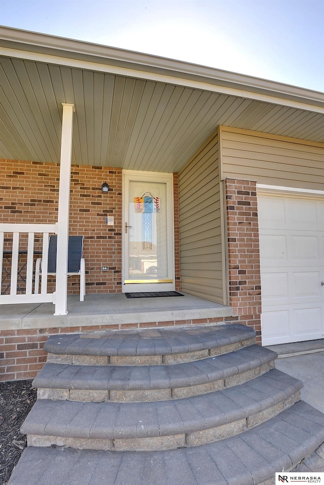 10419 N 150th St, Bennington, NE 68007 - view of exterior entry featuring covered porch and brick siding