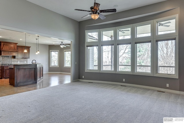 19252 Shirley St, Omaha, NE 68130 - unfurnished living room with ceiling fan, light carpet, and baseboards