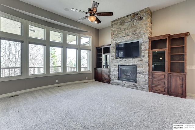 19252 Shirley St, Omaha, NE 68130 - unfurnished living room featuring a fireplace, ceiling fan, baseboards, and carpet floors