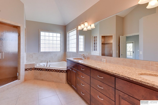 19252 Shirley St, Omaha, NE 68130 - full bathroom featuring vaulted ceiling, double vanity, plenty of natural light, and a garden tub