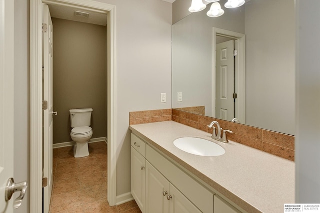 19252 Shirley St, Omaha, NE 68130 - bathroom featuring vanity, toilet, tile patterned floors, and baseboards