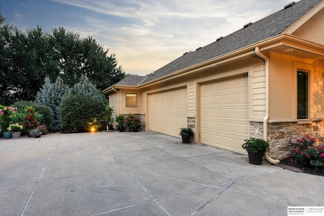 19252 Shirley St, Omaha, NE 68130 - garage at dusk featuring driveway
