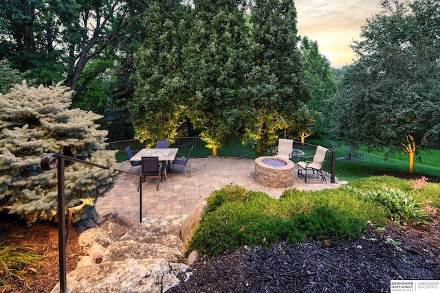 19252 Shirley St, Omaha, NE 68130 - patio terrace at dusk featuring a fire pit and a patio