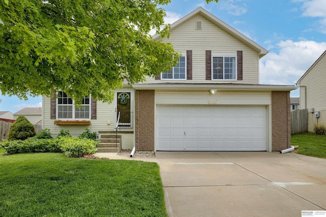 16117 Cottonwood St, Omaha, NE 68136 - view of front of property with concrete driveway, brick siding, and an attached garage