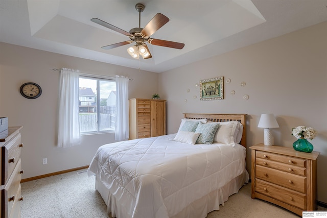 16117 Cottonwood St, Omaha, NE 68136 - bedroom featuring a tray ceiling, light colored carpet, baseboards, and ceiling fan
