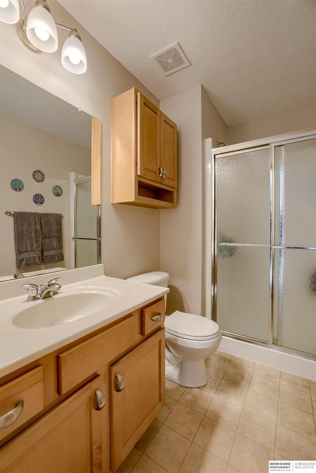 16117 Cottonwood St, Omaha, NE 68136 - full bath featuring vanity, a shower stall, toilet, tile patterned floors, and a textured ceiling