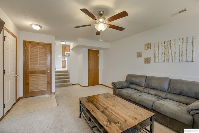 16117 Cottonwood St, Omaha, NE 68136 - living room with ceiling fan, light colored carpet, stairway, and baseboards