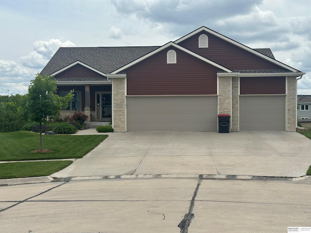 6901 N 13th Cir, Lincoln, NE 68521 - craftsman-style house featuring stone siding, an attached garage, a front lawn, concrete driveway, and roof with shingles