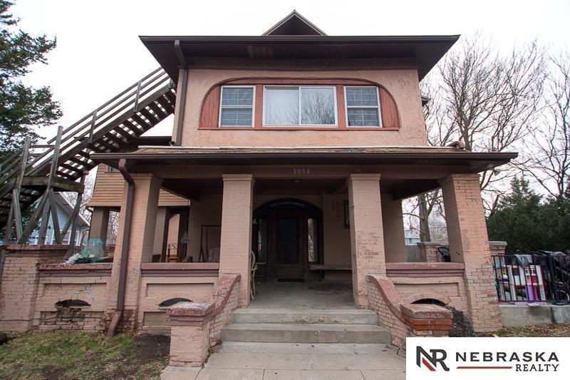 3054 R St, Lincoln, NE 68503 - view of front of house featuring covered porch and brick siding