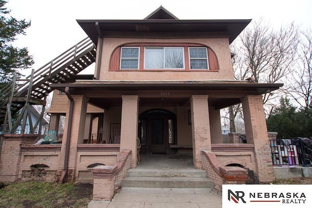 3054 R St, Lincoln, NE 68503 - view of front of house featuring covered porch and brick siding