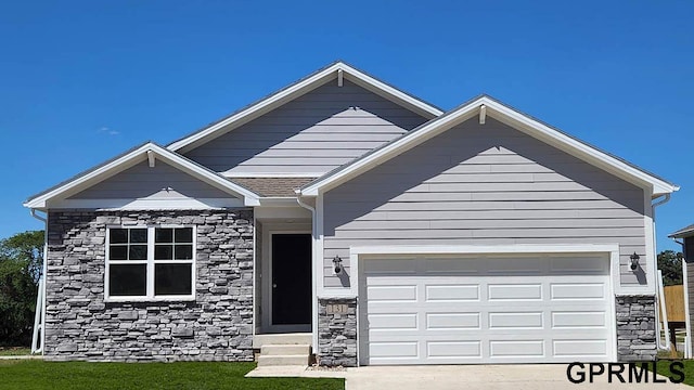 8412 S 176th Ave, Omaha, NE 68137 - view of front of property with stone siding, a garage, concrete driveway, and entry steps