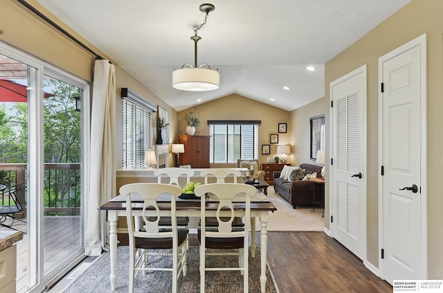 5818 S 159th St, Omaha, NE 68135 - dining space featuring vaulted ceiling, wood finished floors, and a textured ceiling