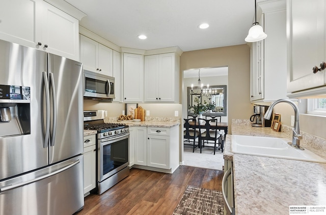 5818 S 159th St, Omaha, NE 68135 - kitchen featuring appliances with stainless steel finishes, a chandelier, a sink, dark wood-type flooring, and white cabinetry