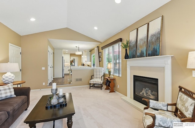 5818 S 159th St, Omaha, NE 68135 - carpeted living room with recessed lighting, lofted ceiling, a glass covered fireplace, and baseboards