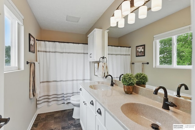 5818 S 159th St, Omaha, NE 68135 - bathroom with stone finish flooring, toilet, double vanity, and curtained shower