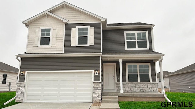 16333 Davidson St, Bennington, NE 68007 - craftsman-style house with covered porch, a garage, stone siding, and driveway