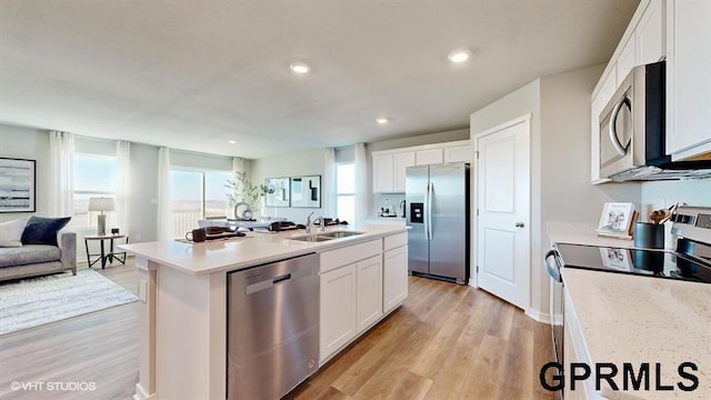 16401 Davidson St, Bennington, NE 68007 - kitchen featuring stainless steel appliances, a sink, white cabinetry, open floor plan, and light wood-style flooring