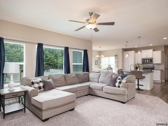15218 Vane St, Bennington, NE 68007 - living area featuring a chandelier, ceiling fan, wood finished floors, and recessed lighting