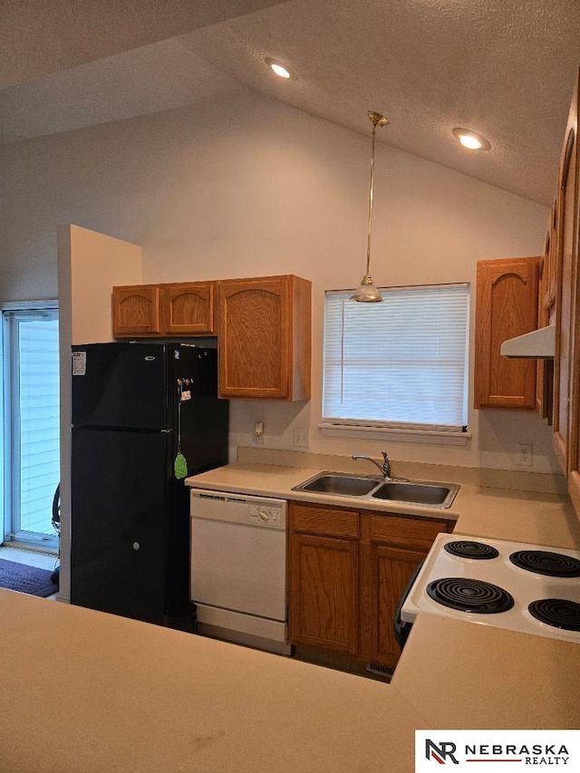 4555 Meredith Ave, Omaha, NE 68104 - kitchen with white appliances, a sink, under cabinet range hood, vaulted ceiling, and brown cabinetry