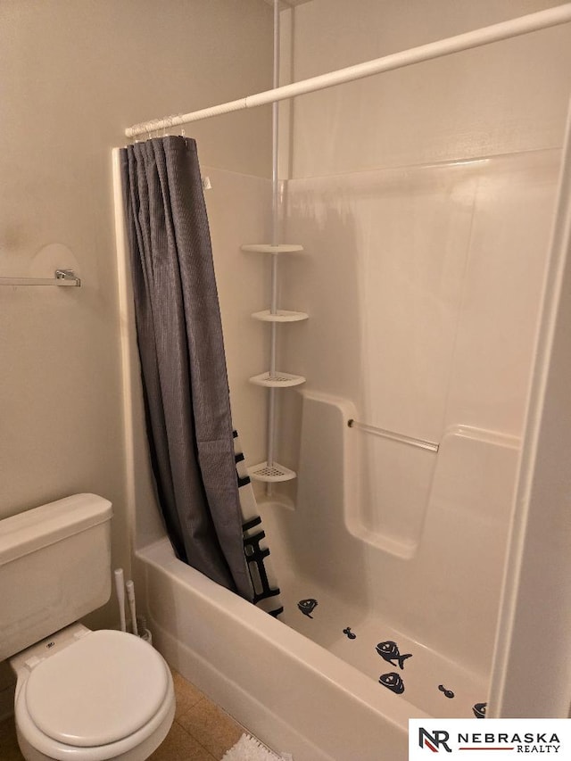 4555 Meredith Ave, Omaha, NE 68104 - bathroom featuring toilet, tile patterned floors, and shower / bath combo with shower curtain
