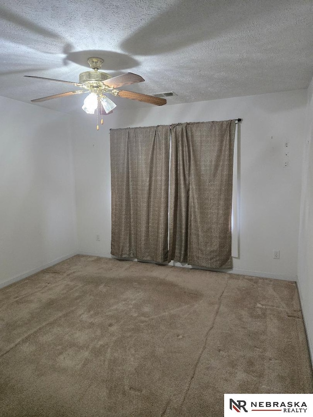 4555 Meredith Ave, Omaha, NE 68104 - unfurnished room with carpet floors, a textured ceiling, and a ceiling fan