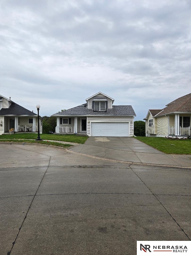 4555 Meredith Ave, Omaha, NE 68104 - view of front of house with concrete driveway, a garage, a front yard, and a porch