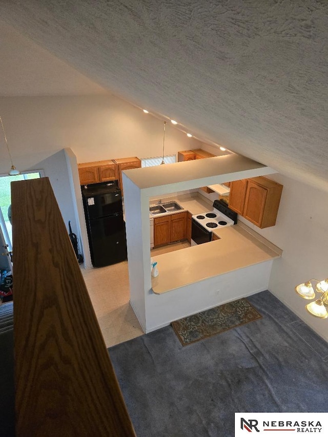 4555 Meredith Ave, Omaha, NE 68104 - kitchen featuring range with electric stovetop, freestanding refrigerator, lofted ceiling, brown cabinetry, and a textured ceiling