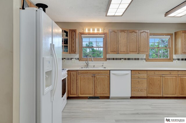 7105 W Davey Rd, Raymond, NE 68428 - kitchen featuring white appliances, a sink, healthy amount of natural light, and light wood-style floors