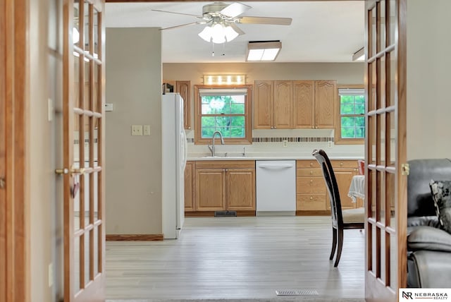 7105 W Davey Rd, Raymond, NE 68428 - kitchen featuring white appliances, a sink, ceiling fan, light wood finished floors, and healthy amount of natural light