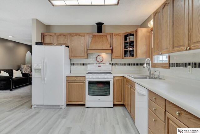 7105 W Davey Rd, Raymond, NE 68428 - kitchen featuring white appliances, a sink, tasteful backsplash, light wood-type flooring, and glass insert cabinets