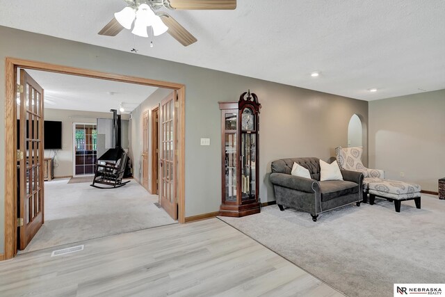 7105 W Davey Rd, Raymond, NE 68428 - carpeted living room with french doors, wood finished floors, ceiling fan, baseboards, and recessed lighting