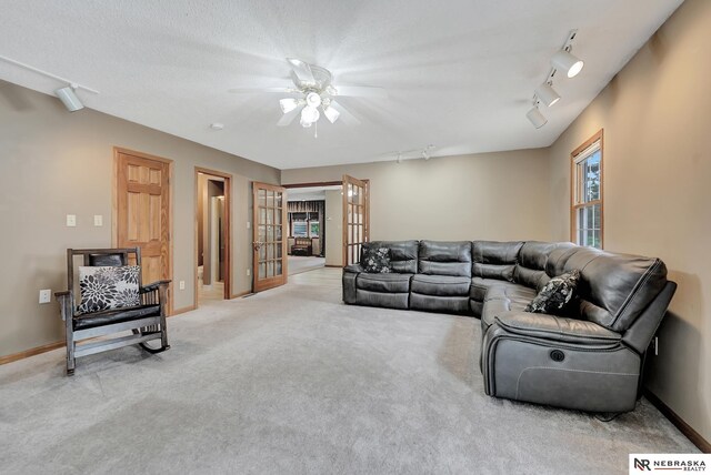 7105 W Davey Rd, Raymond, NE 68428 - living room with ceiling fan, carpet flooring, rail lighting, french doors, and baseboards