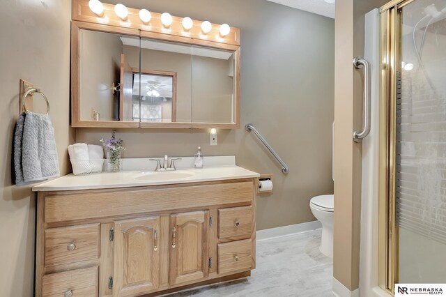7105 W Davey Rd, Raymond, NE 68428 - bathroom with vanity, a stall shower, toilet, and baseboards