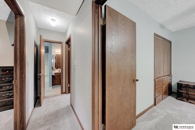 7105 W Davey Rd, Raymond, NE 68428 - corridor with a textured ceiling, light colored carpet, and baseboards